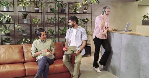 Diverse team enjoying relaxation in modern office lounge