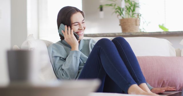 Smiling Woman Relaxing on Couch Having Phone Conversation at Home - Download Free Stock Images Pikwizard.com