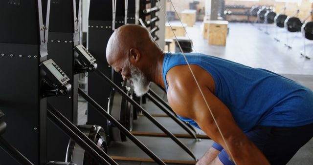 senior man exercising on rowing machine in fitness gym - Download Free Stock Images Pikwizard.com