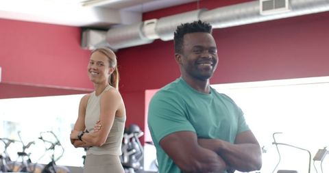 Confident Multiracial Fitness Enthusiasts Smiling at Gym