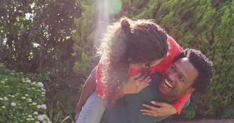 Joyful couple celebrating engagement in sunny garden