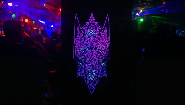 Neon animal artwork illuminating vibrant nightclub
