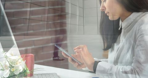 Caucasian Businesswoman Engaged with Smartphone in Modern Office