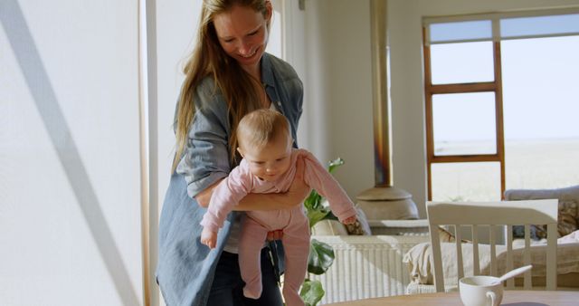 Mother Cradling Baby in Sunlit Living Room - Download Free Stock Images Pikwizard.com