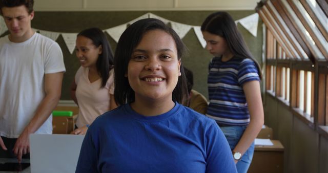 Confident Teenage Girl Smiling in Classroom with Classmates - Download Free Stock Images Pikwizard.com