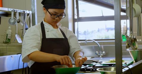 Focused Chef Preparing Ingredients in Professional Kitchen