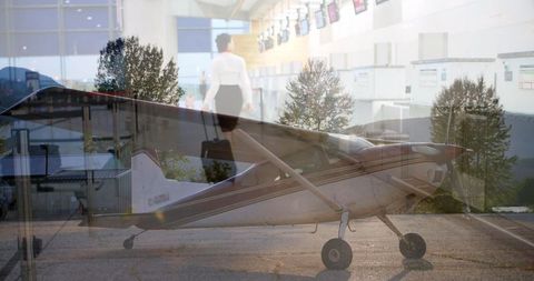 Businesswoman at Airport with Propeller Airplane Background - Download Free Stock Images Pikwizard.com