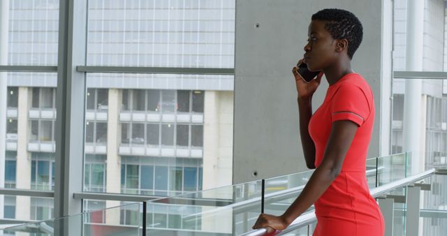 Professional Woman in Red Dress on Phone in Modern Office Building - Download Free Stock Images Pikwizard.com