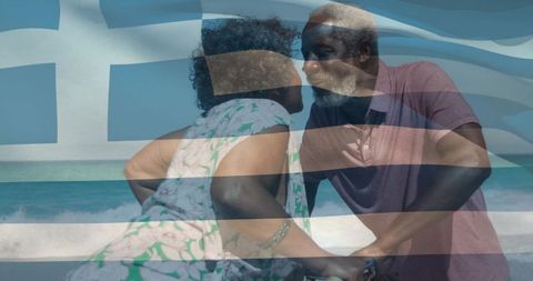 Senior couple leaning and embracing on greek coastline with flag double exposure