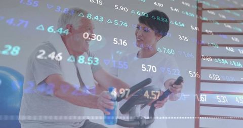 Senior man exercising with physiotherapist monitoring data