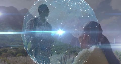 Innovative Professionals Analyzing Holographic Sphere Outdoors