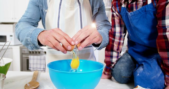 Hands Cracking Egg Into Blue Bowl in Kitchen - Download Free Stock Images Pikwizard.com