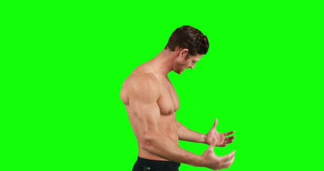 Shirtless muscular man is expressing intense shock or surprise, gesturing with his hands, positioned against a green screen background. Ideal for use in fitness, sports-related media, emotional expression concepts, or adding custom backdrops in post-production.