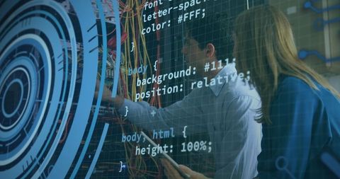 It technicians collaborating on network infrastructure with code overlay