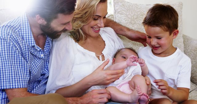 Happy Family with Mother, Father, Baby, and Toddler Bonding Together - Download Free Stock Images Pikwizard.com