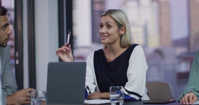 Businesswoman Leading Meeting with Colleagues in Modern Office - Download Free Stock Images Pikwizard.com