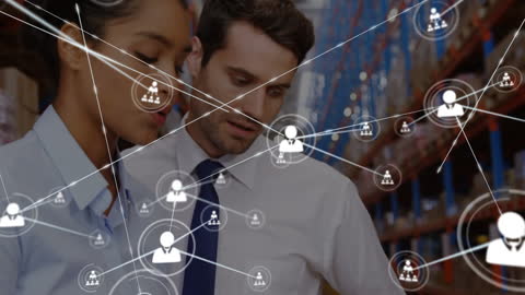 Business Professionals Analyzing Digital Connections in Warehouse