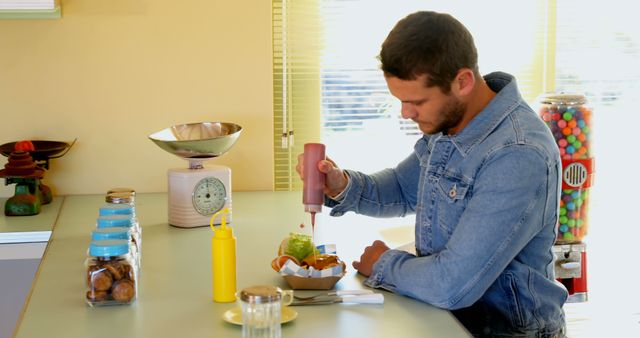 Man Adding Ketchup to Burger in Vintage Diner - Download Free Stock Images Pikwizard.com