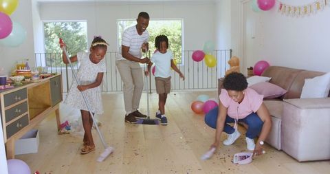 Family Cleaning Up After Celebration at Home