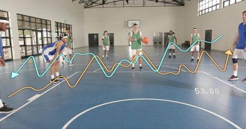 Basketball players using performance analytics during indoor team practice