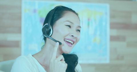 Asian Businesswoman using Call Center Headset with Digital Overlay