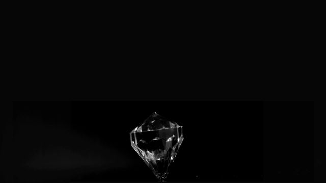 Elegant crystal stone spinning in super slow motion against black background. Suitable for advertisements, luxury brand promotions, jewelry design references, and high-end product presentations.