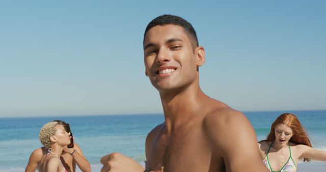 Young Adults Enjoying a Beach Party under Clear Blue Sky - Download Free Stock Images Pikwizard.com