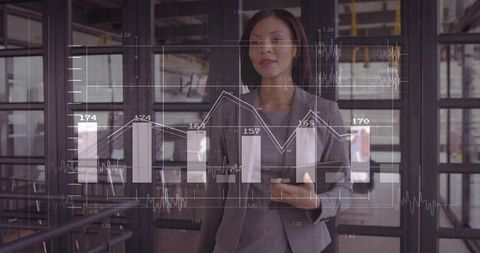 Business Executive Analyzing Digital Bar Graphs on Screen