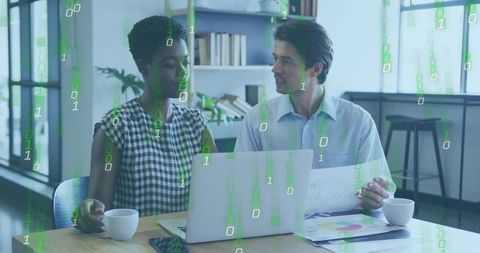 Professionals Collaborating Over Laptop with Binary Data Overlay in Modern Office