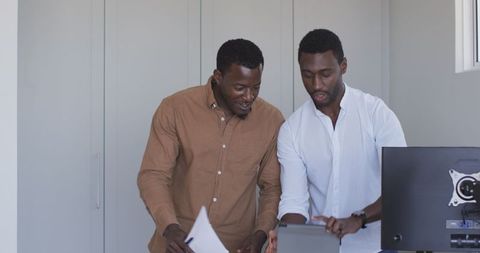 Business partnership shaking hands indoors