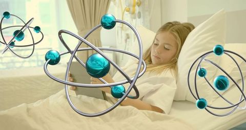 Child reading tablet in hospital bed with atom models symbolizing pediatric science and recovery