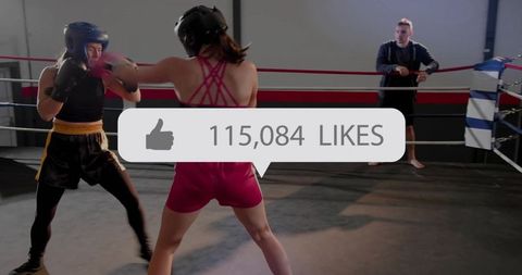 Women boxing sparring in ring with social media likes overlay 115,084
