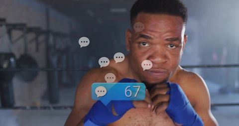 Boxer training in ring holding guard with blue hand wraps and chat bubble notification