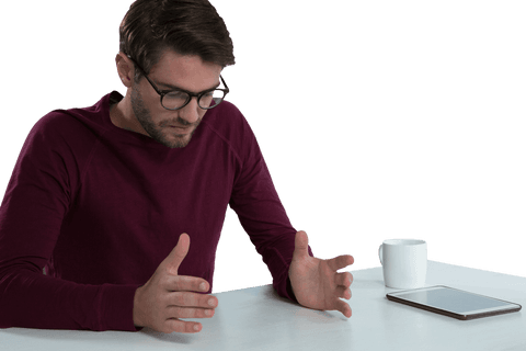 Man Holding Transparent Object at Desk Relaxed Expression - Download Free Stock Videos Pikwizard.com