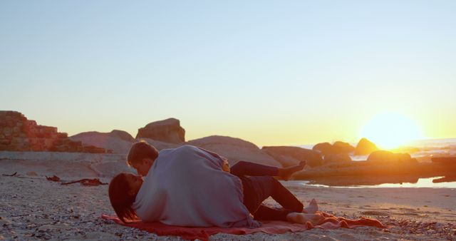 Couple Relaxing on Beach During Sunset with Blanket - Download Free Stock Images Pikwizard.com