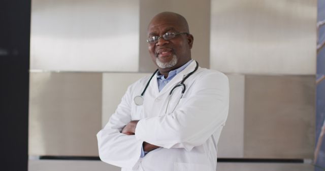 Confident Senior Doctor Standing with Folded Arms in Hospital - Download Free Stock Images Pikwizard.com