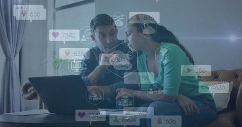 Couple Analyzing Social Media Metrics on Laptop in Cozy Living Room Setting