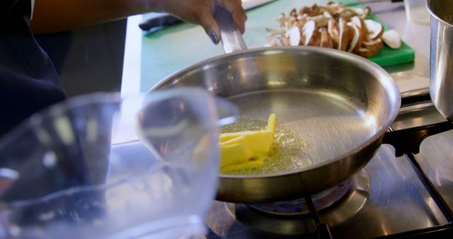 Chef Melting Butter in Pan with Sliced Mushrooms for Cooking - Download Free Stock Images Pikwizard.com