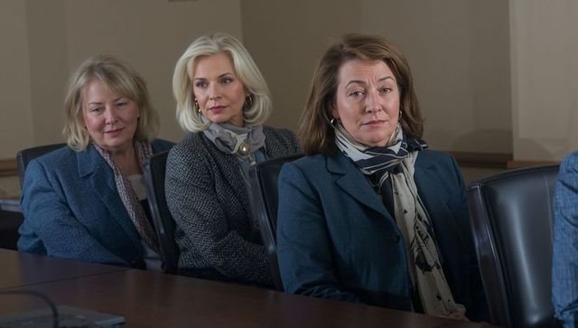 Women executives listening intently in conference room, corporate meeting, business focus