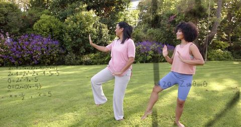 Two women practicing balance and mindful movement on backyard lawn with math overlay