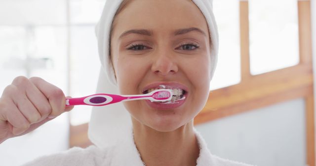 Young Woman Brushing Teeth in Bathroom with Towel Wrapped Around Head - Download Free Stock Images Pikwizard.com