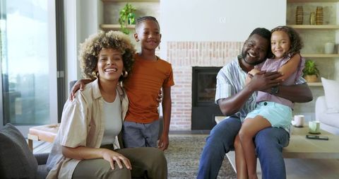 Happy Family Bonding at Home with Brick Fireplace Background
