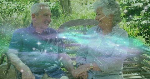 Happy Senior Couple Sharing Joyful Moment on Garden Bench