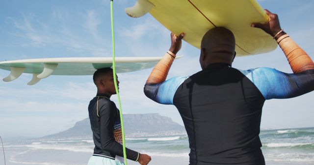 Father and Son Carrying Surfboards at Beach - Download Free Stock Images Pikwizard.com