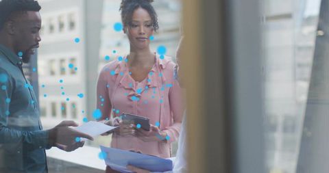 Business Professionals Analyzing Data Together on Office Terrace