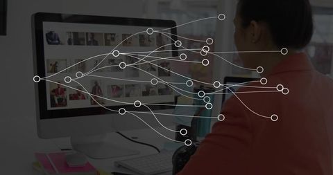 Creative editor reviewing thumbnails on desktop with dslr, workflow nodes and workspace