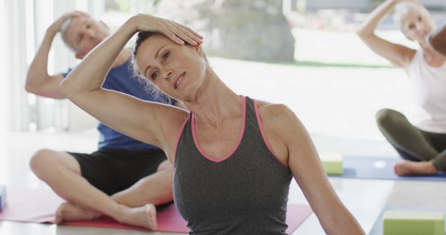 Senior Adults Participating in Yoga Class Performing Stretching Exercise - Download Free Stock Images Pikwizard.com