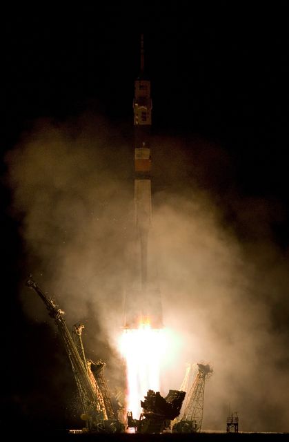 Soyuz TMA-11 launching from Baikonur Cosmodrome at night. Ideal for space exploration topics, astronaut missions, historical space events, and scientific research articles. Captures the moment of lift-off to the International Space Station in October 2007, showcasing technology and teamwork in space missions.