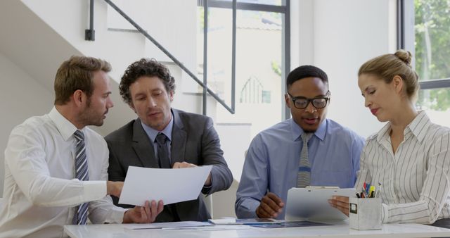 Multiracial Business Team Analyzing Documents in Meeting - Download Free Stock Images Pikwizard.com