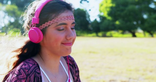 Woman listening to headphones on a summers day  - Download Free Stock Photos Pikwizard.com